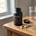 Evenfall Magnesium Glycinate — bottle and capsules on a nightstand