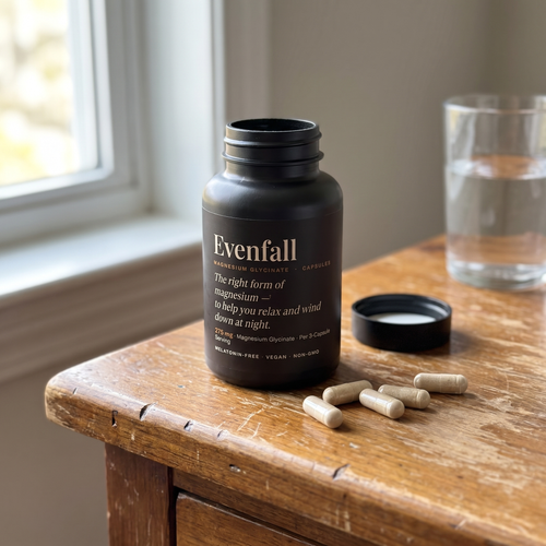 Evenfall Magnesium Glycinate — bottle and capsules on a nightstand